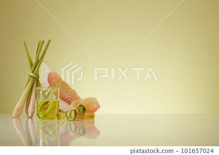 Essential oil extracted from lemongrass and pink pomelo (Citrus maxima) contained inside laboratory glassware. Healthy concept with many benefits for body, skin and hair 101657024