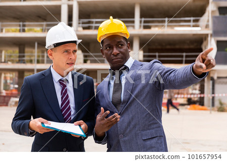 Two engineers discussing new construction Two engineers discussing new construction 101657954