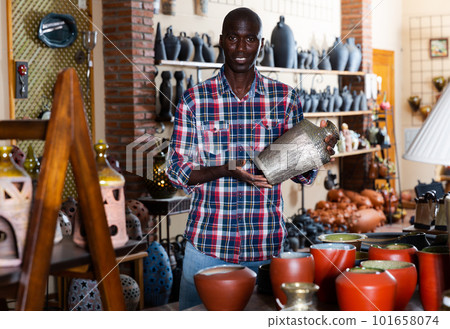 Male shop assistant in pottery shop 101658074