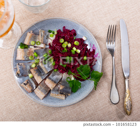 Lightly salted herring with beets served on platter 101658123