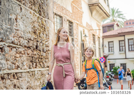 Mom and son tourists in Old town Kaleici in Antalya. Turkiye. Panoramic view of Antalya Old Town port, Taurus mountains and Mediterrranean Sea, Turkey. Traveling with kids concept Mom and son tourists in Old town Kaleici in Antalya. Turkiye. Panoramic view of Antalya Old Town port, Taurus mountains and Mediterrranean Sea, Turkey. Traveling with kids concept 101658326