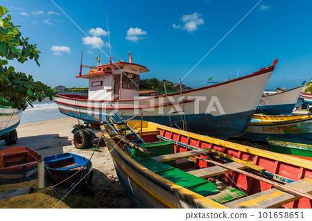 Local boats on Matadeiro beach and ocean in sunny day. Colorful boats on beach in Florianopolis 101658651