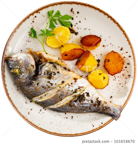 Grilled dorada with baked potatoes, lemon and greens Grilled dorada with baked potatoes, lemon and greens 101658670
