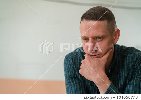 Portrait of a pensive caucasian man in a workshop. Portrait of a pensive caucasian man in a workshop. 101658778