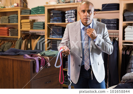 Man choosing new tie in clothing boutique 101658844