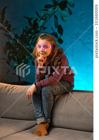 Teenager girl in neon light room Teenager girl in neon light room 101660009