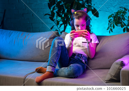 Teenager girl in neon light room 101660025