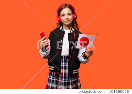 Girl holds small flag Japan 101660056