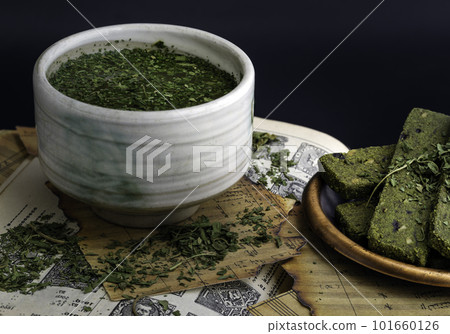 Enjoy with A Cup of CBD herbal tea is served with the Homemade Cannabis Snack Sticks on the Old Music Notebook. 101660126