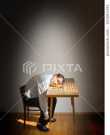 A head of man dropped into a plate with soup on a levitating table A head of man dropped into a plate with soup on a levitating table 101661491