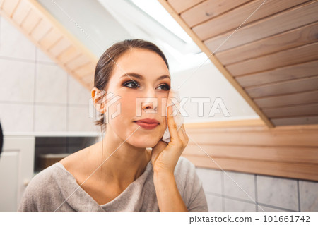 Close up woman cleaning her face make up with a cotton pad Close up woman cleaning her face make up with a cotton pad 101661742