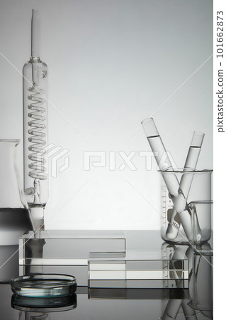 Test tube, petri dish filled with water and laboratory glassware displayed with rectangle transparent podium. Blank space for product advertisement 101662873