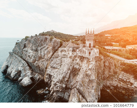 Crimea Swallow's Nest Castle on the rock over the Black Sea. It is a tourist attraction of Crimea. Amazing aerial view of the Crimea coast with the castle above abyss on sunny day. 101664779
