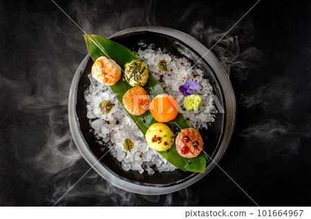 Temari sushi on a black plate with ice Temari sushi on a black plate with ice 101664967