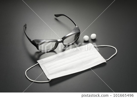 White mask and glasses placed on the desk 101665496