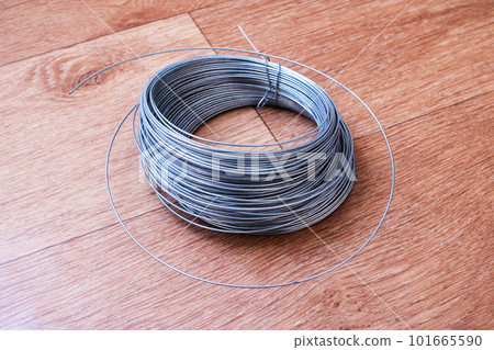 Large coil of wire on the table Large coil of wire on the table 101665590