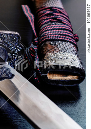 Samurai sword on a black wooden table Samurai sword on a black wooden table 101665617