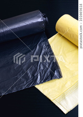 Yellow and gray garbage bags on wooden table Yellow and gray garbage bags on wooden table 101665618