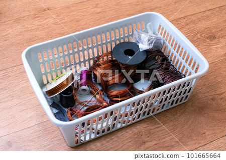 Copper wire coils in a plastic basket 101665664