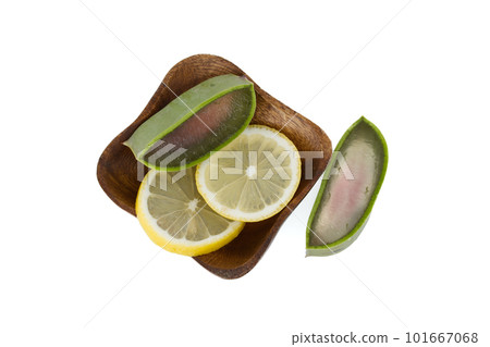 Aloe Vera and lemon slices in wooden plate isolated on white Aloe Vera and lemon slices in wooden plate isolated on white 101667068