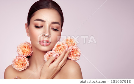 Beautiful young woman with a rose flower Beautiful young woman with a rose flower 101667918