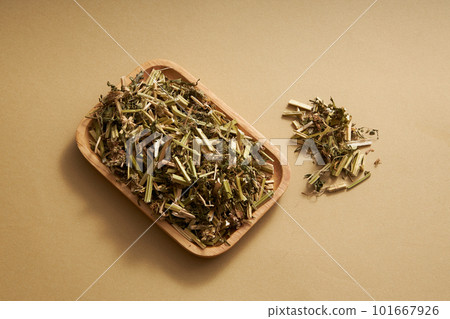 Chinese motherwort on wooden dish displayed on beige background. Chinese motherwort (Leonurus japonicus) is a precious medicinal plant for women with the ability to cure common diseases in women 101667926