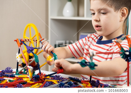 A little boy plays with a constructor, creating figures from gears and sticks. Development of logic and thinking in children A little boy plays with a constructor, creating figures from gears and sticks. Development of logic and thinking in children 101668003