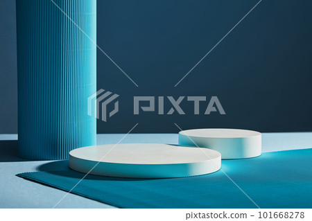 Front view of two white round empty podiums on dark blue background. Minimal art background with copy space for cosmetics product presentation Front view of two white round empty podiums on dark blue background. Minimal art background with copy space for cosmetics product presentation 101668278