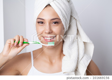 Healthy white teeth, portrait of beautiful young woman brushing teeth 101669156