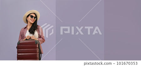Elegant beautiful woman dressed in summer clothes with luggage isolated purple background with copy space for your graphic design 101670353