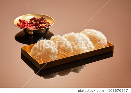 Edible bird nest placed on a golden dish decorated with a dish of jujube and dried goji berries. Health and skin condition can be enhanced by eating bird nest with herbs Edible bird nest placed on a golden dish decorated with a dish of jujube and dried goji berries. Health and skin condition can be enhanced by eating bird nest with herbs 101670557
