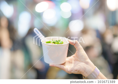 woman hand holding Rice Noodle in paper bowl at Ximending night market, famous Taiwanese Street Food of Taiwan. exotic food in local market woman hand holding Rice Noodle in paper bowl at Ximending night market, famous Taiwanese Street Food of Taiwan. exotic food in local market 101671389