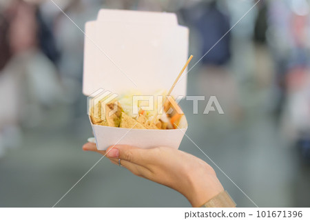 woman hand holding Stinky Tofu at night market, famous Taiwanese Street Food of Taiwan. exotic food in local market 101671396
