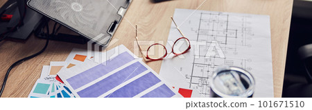 Close up shot of glasses, architectural blueprint with papers and color samples, thermos flask on creative desk 101671510