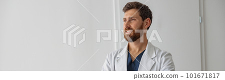 Portrait of handsome doctor in uniform standing in medicine clinic hall and looking away Portrait of handsome doctor in uniform standing in medicine clinic hall and looking away 101671817