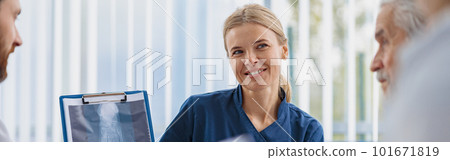 Group of doctors sitting at meeting table in conference room during medical seminar 101671819
