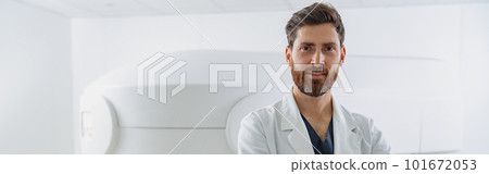Radiologist on background of MRI or CT or PET Scan with female patient undergoing procedure 101672053