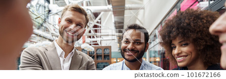Happy group of multi ethnic coworkers stacked hands together as concept of corporate unity 101672166