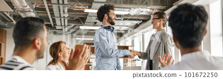Smiling female boss leader shaking hand of new team member recruiting him for job on staff briefin 101672250