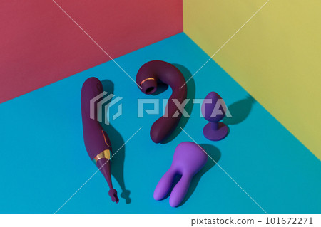 Top view of buttplug and dildos vibrator for sex on colored background. Sex shop concept Top view of buttplug and dildos vibrator for sex on colored background. Sex shop concept 101672271