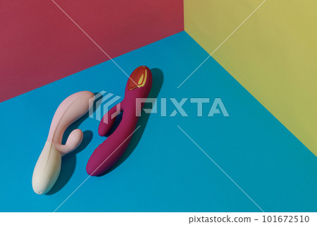 Two dildo vibrators for satisfaction on colored background. Sex toy for adult. Sex shop concept 101672510