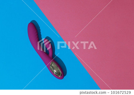 Top view of violet dildo vibrator on colored background. Sex toy for adult. Sex shop concept 101672529