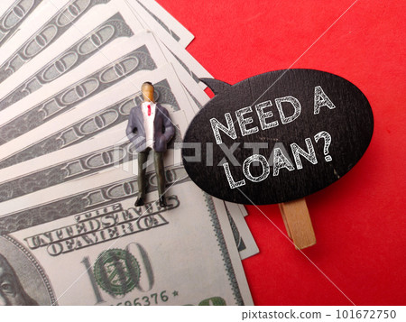 Banknotes and miniature people with the word NEED A LOAN on red background. 101672750
