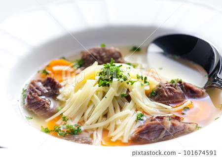 beef broth with noodles and carrot 101674591
