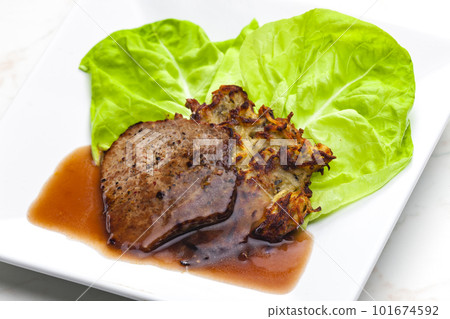 beef steak with sauce served with potato pankcakes beef steak with sauce served with potato pankcakes 101674592