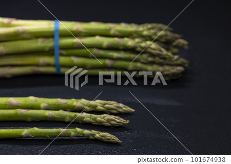 Green asparagus on black background Green asparagus on black background 101674938