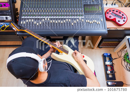 top view of male musician enjoy playing and recording electric guitar in home studio top view of male musician enjoy playing and recording electric guitar in home studio 101675780