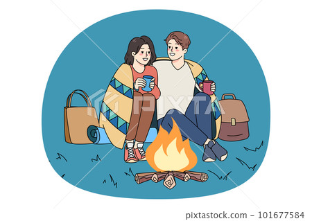Happy couple sit near fire on romantic date Happy couple sit near fire on romantic date 101677584