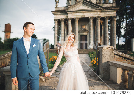 Wedding couple holding hands, groom and bride together on wedding day 101679274