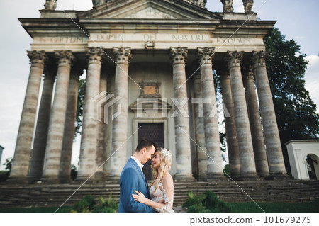 Gorgeous happy couple standing close to each other and looking in eyes 101679275